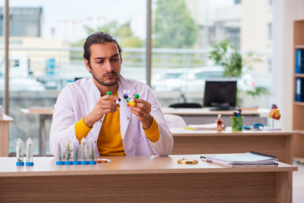 Young male chemist in drug synthesis concept - Photo, Image
