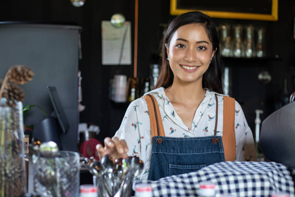 Азиатские женщины Бариста улыбаясь и используя кофеварку в кафе счетчик - Рабочая женщина владелец малого бизнеса питание и напитки кафе концепции - Фото, изображение