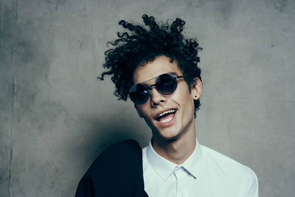 emotional guy with curly hair teen classic suit sunglasses shirt model - Fotó, kép