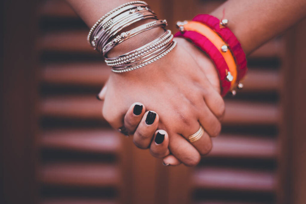 A closeup shot of two people holding the hands of each other - Photo, image