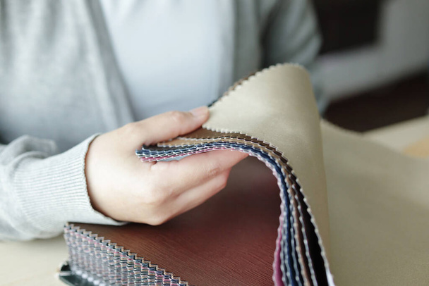female designer with fabric color samples choosing textile for curtains - Fotoğraf, Görsel