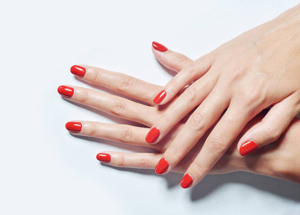 A closeup shot of female hands with red nail polish - Zdjęcie, obraz
