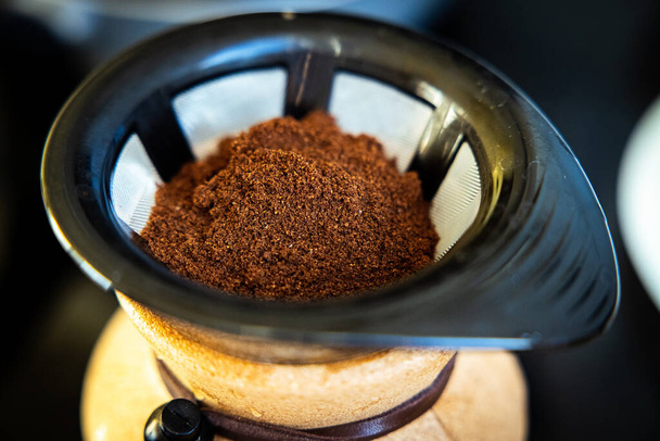 The ground coffee is put in a coffee maker filter for brewing - Foto, Bild