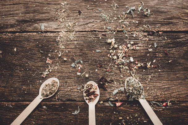 The three spoons filled with aromatic spice on a wooden table - Foto, Imagem