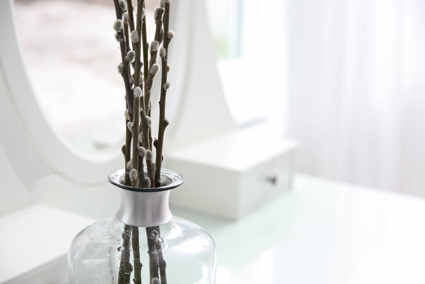 Beautiful blooming pussy willow branches on white dressing table indoors, closeup. Space for text - Фото, изображение