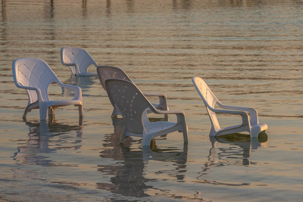 Chairs people abandoned overnight in the Dead Sea in Israel - Photo, Image