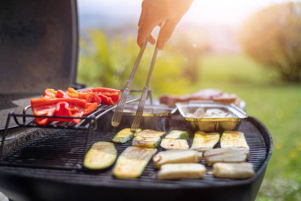 Close up of cheese and vegetables on gas grill. Summer time, outdoors. - Foto, Imagen