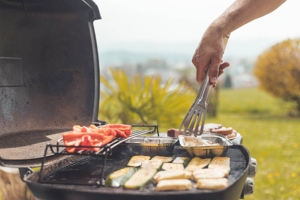 Close up of cheese and vegetables on gas grill. Summer time, outdoors. - Fotoğraf, Görsel