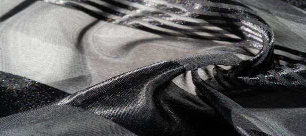 Silk fabric. light transparent silk fabric with stripes of different sizes, black. texture, background, pattern, - 写真・画像