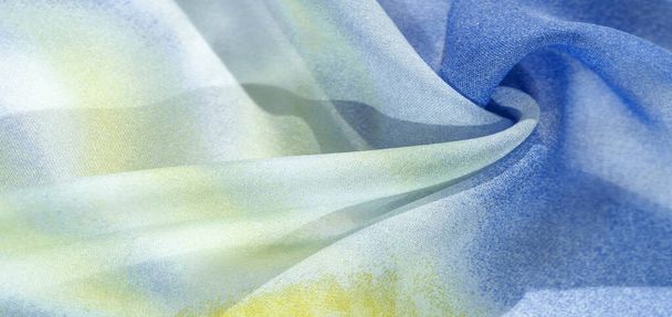 silk fabric in soft blue, yellow and white tones with abstract patterns and bed tones. Texture, pattern, collection - Photo, Image