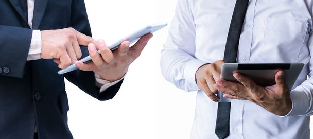 Business man standing on a white background isolated from the wall Use a tablet computer, dressed in white shirts and black suits. - Foto, Imagem