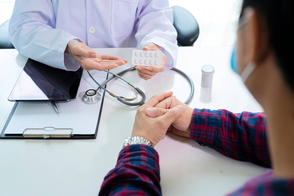 Doctor having conversation with patient while discussing explaining symptoms or counsel diagnosis health and consult treatment of disease, healthcare and assistance concept. - Photo, image