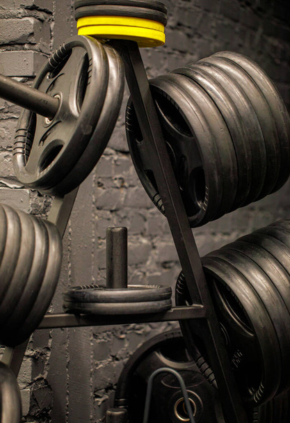 Weights in a workout gym. Gym interior close up, machinery and weightlifting equipment in modern urban style. - Photo, Image