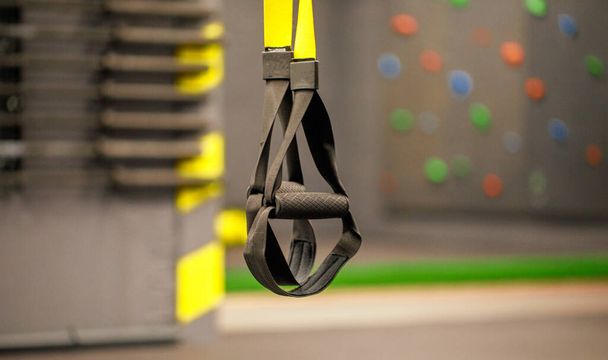 Trx straps in urban modern gym. A fitness equipment called trx that was prepared for playing at noon in a gym. - Фото, изображение