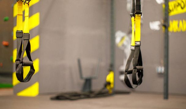 Trx straps in urban modern gym. A fitness equipment called trx that was prepared for playing at noon in a gym. - Foto, immagini