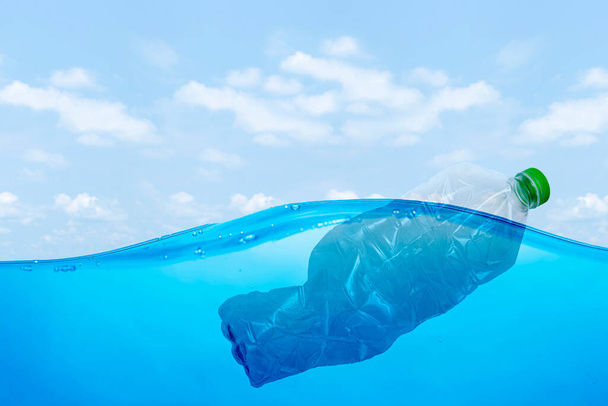 plastic waste at the ocean, a plastic bottle floating in the Mediterranean sea at the water surface, environmental problem with plastics pollution, copy space for text - 写真・画像