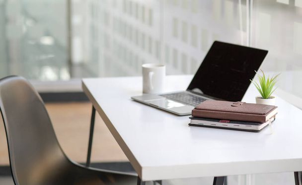 Cropped shot of Notebooks and laptop on the desk in a modern office. - Foto, imagen