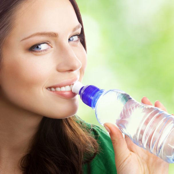 Woman drinking water from bottle, outdoor - 写真・画像