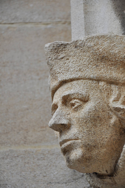 Close-up of decorative stone head carving on wall of Bodleian library courtyard, Oxford, United Kingdom. Selective focus. - Photo, image