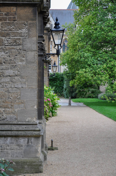 View of building facade, trees & lawn from Trinity College Front Quad, Oxford, United Kingdom. Overcast Sky. - 写真・画像