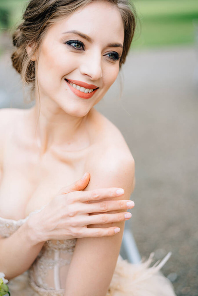 Noiva sorridente em um vestido bonito colocar a mão em seu ombro. Retrato - Foto, Imagem