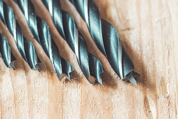 Close up of driller lying on wooden plank - Foto, Imagem