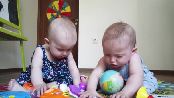 Two girls sisters, playing with toys on the floor at home - Footage, Video