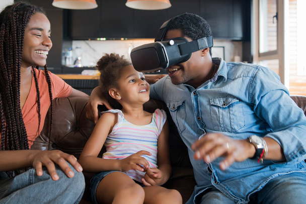 Family playing video games with VR glasses. - Fotó, kép
