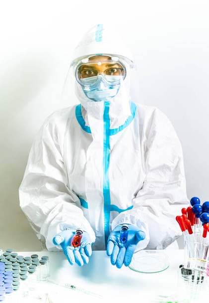 Different Covid 19 vaccines presented by laboratory scientist nurse. Various coronavirus vaccine choice. Pandemic prevention and immunization. Doctor in ppe shows vaccination research.  - Foto, Imagem