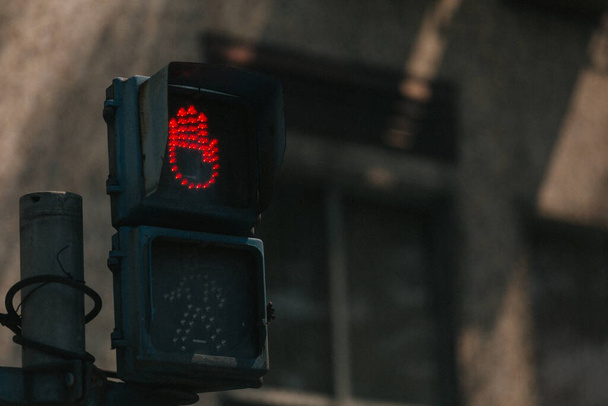 A closeup shot of an illuminated red hand sign on a pedestrian light - Foto, immagini
