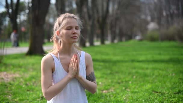 Cvičení jógy a meditace venku. Dívka v parku - Záběry, video