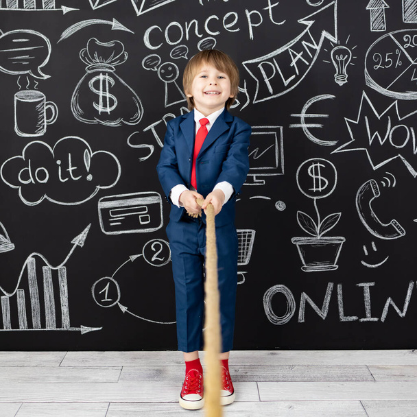 Bright idea! Funny child student in class against black chalkboard. Happy kid pretend to be businessman. Online education and e-learning concept. Back to school - Foto, imagen