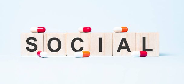 social word made on wooden cube blocks and flower in a pot on background. Health and medicine concept. Healthcare concept. - Photo, image