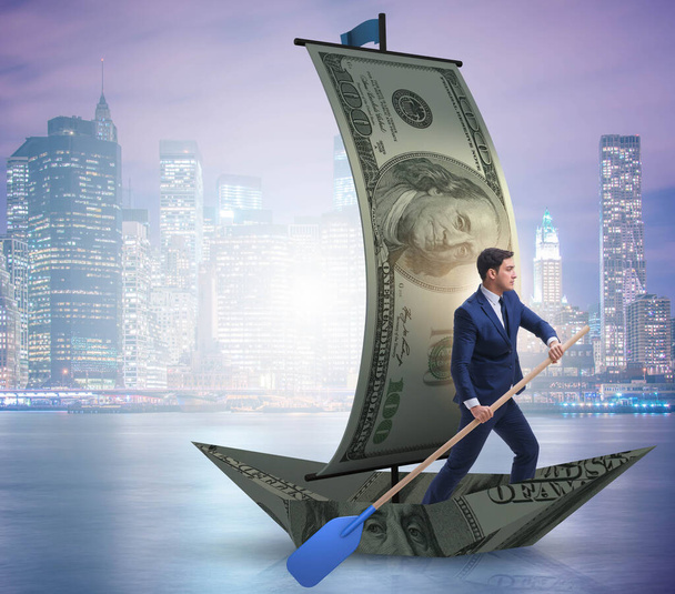 Üzletember evezés dollár hajó az üzleti pénzügyi koncepció - Fotó, kép