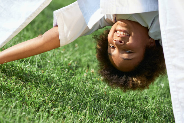 Cheerful Afro American girl doing exercise outdoors - Valokuva, kuva