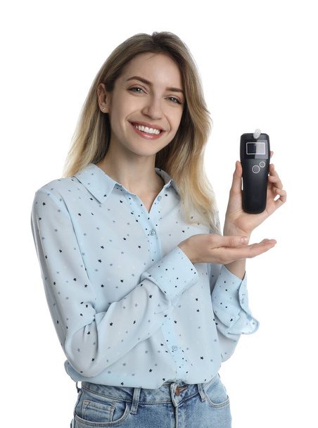 Young woman with modern breathalyzer on white background - Foto, Bild
