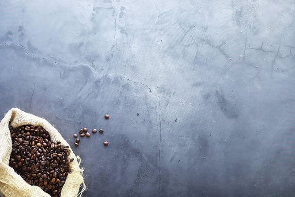 Un sac de café. Les grains de café rôtis sur la table. grains de café avec des feuilles pour la cuisson. - Photo, image