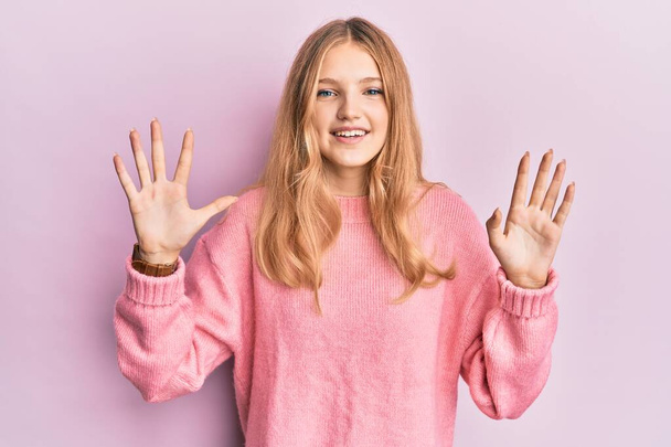 Beautiful young caucasian girl wearing casual clothes showing and pointing up with fingers number ten while smiling confident and happy.  - Fotografie, Obrázek