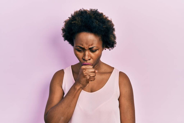 Young african american woman wearing casual sleeveless t shirt feeling unwell and coughing as symptom for cold or bronchitis. health care concept.  - Photo, Image
