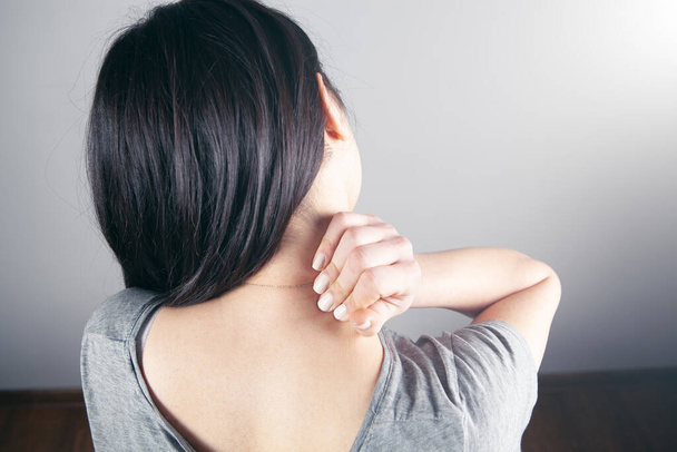 close-up on a woman's hand massaging her neck. Girl's neck hurts - Photo, image