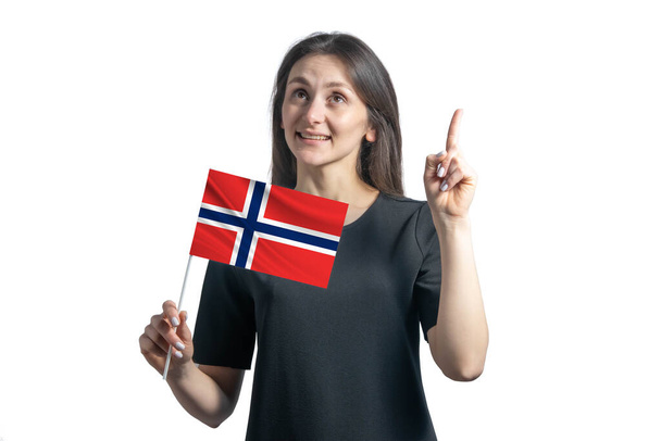 Happy young white woman holding flag of Norway and points thumbs up isolated on a white background. - Foto, Imagem