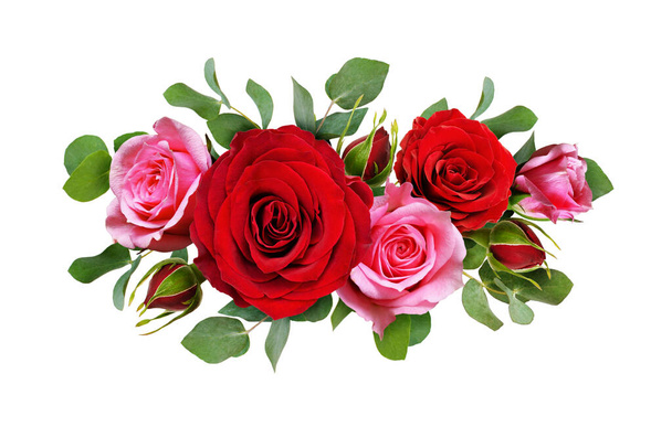 Red and pink rose flowers with eucalyptus leaves in a floral arrangement isolated on white background. Flat lay. Top view. - Foto, afbeelding