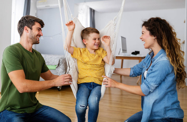 Happy young family having fun time at home - Фото, изображение