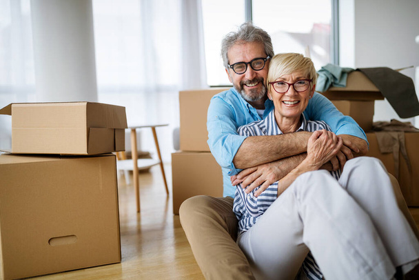 Portrait of happy smiling senior couple in love moving in new home - Фото, изображение