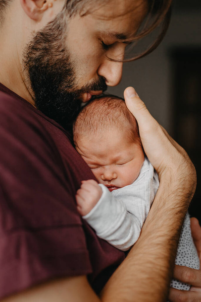 home photos of a newborn baby in the arms of father. Selective focus, noise effect - Фото, зображення