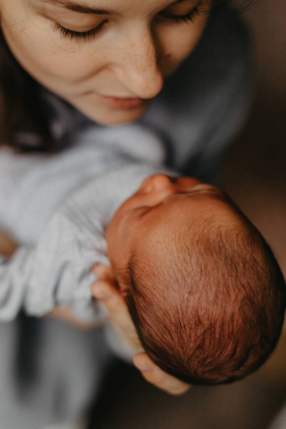 home photos of a newborn baby in the arms of one parent - Fotoğraf, Görsel