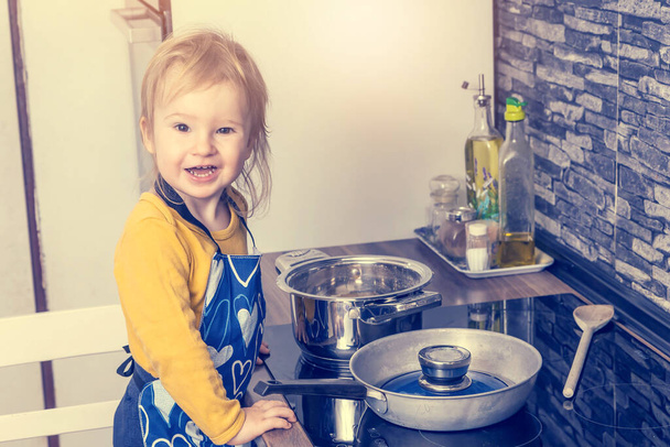 Smiling cute little boy is posing in the kitchen. Horizontally.  - Zdjęcie, obraz