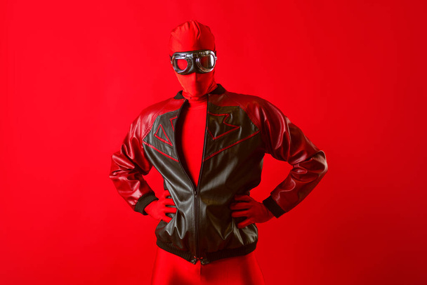 A funny super hero in a red leotard and protective glasses - Foto, Imagem