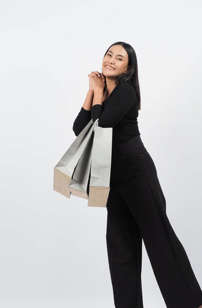 Love Shopping concept. Beautiful Asian woman carrying gray color bags shopping online. isolated on white studio background. online shopping bag. black hair woman love shopping online. Online purchase - Fotoğraf, Görsel