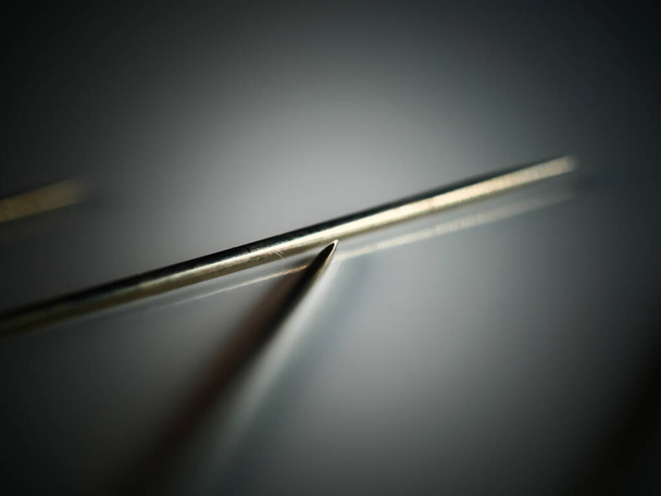 Needle for sewing on a white background. DOF, selective focus - Foto, Imagem